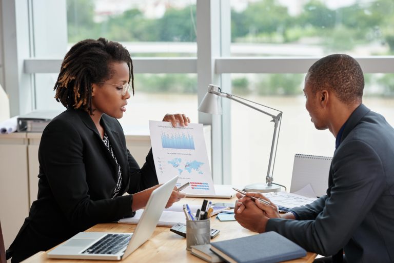 side-view-businesswoman-showing-analytical-charts-her-male-coworker